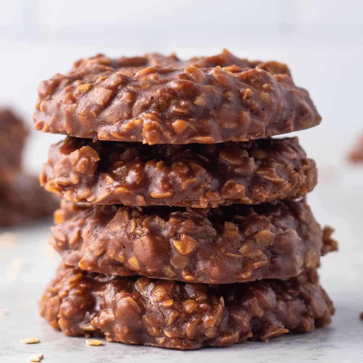 A straight shot of four stacked vegan no-bake cookies.